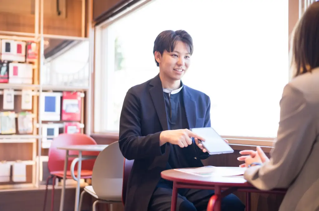 男性スタッフがお客様にプラン説明をしている